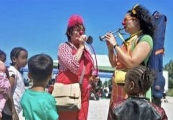 Migrants waiting for small boats to UK entertained by red-nosed clowns