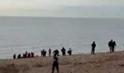 Moment '30 migrants' arrive in small boat before heading to UK town