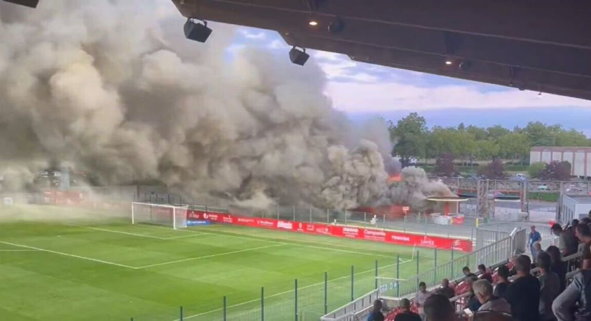 Football stadium evacuated after huge fire breaks out during match as smoke clouds pitch | Football | Sport